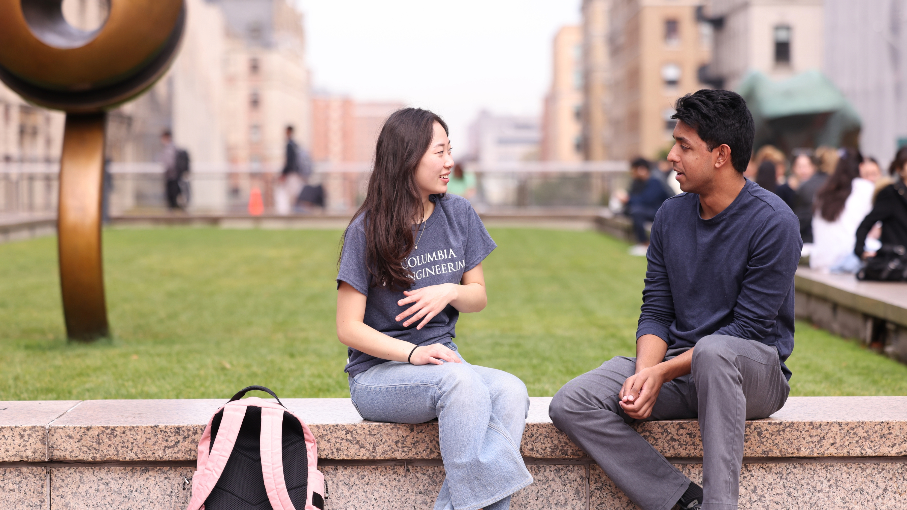 A student talks to an Admissions rep on the lawn at Columbia Engineering.