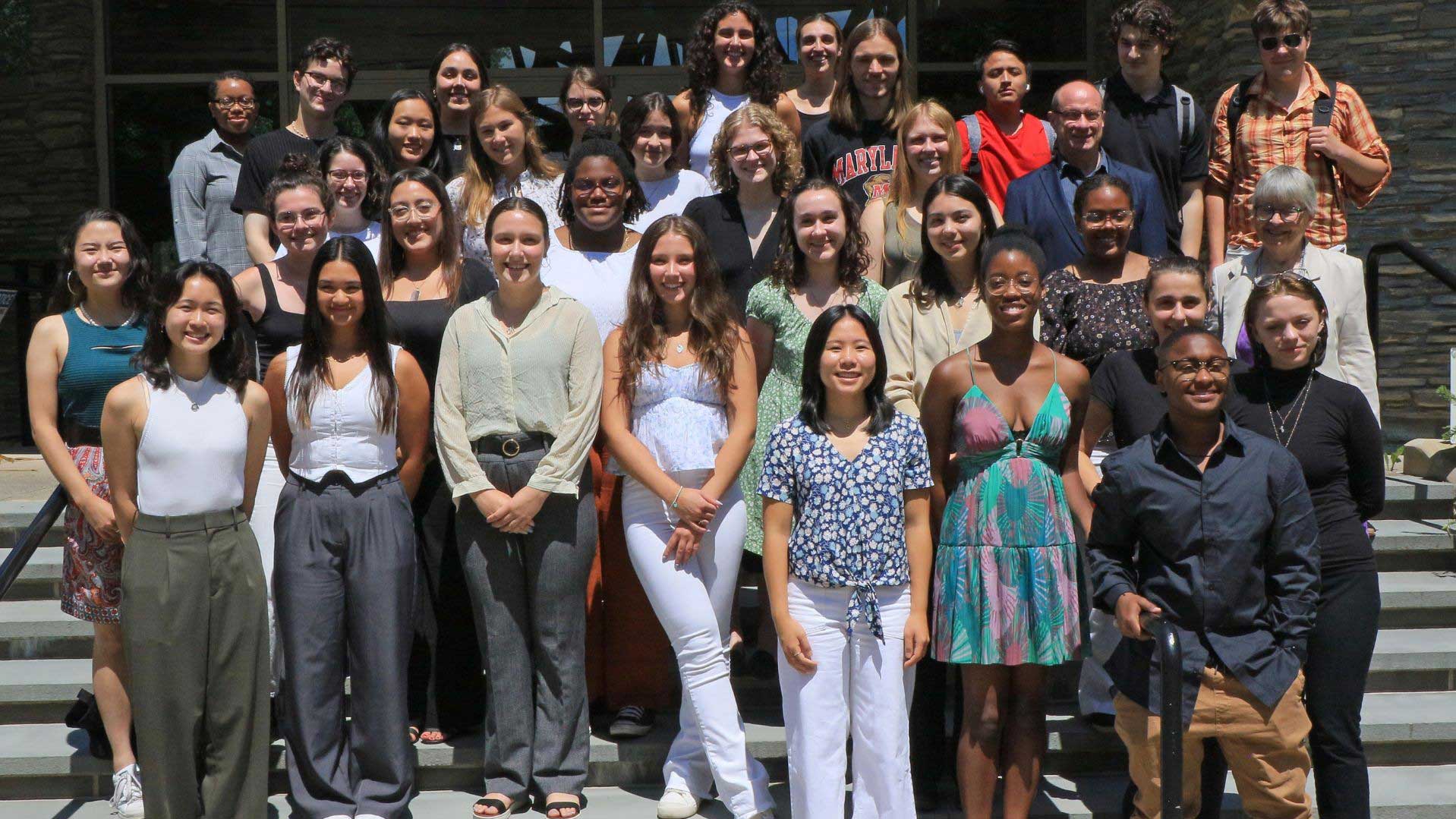 students in a summer program lined up on steps for a photo