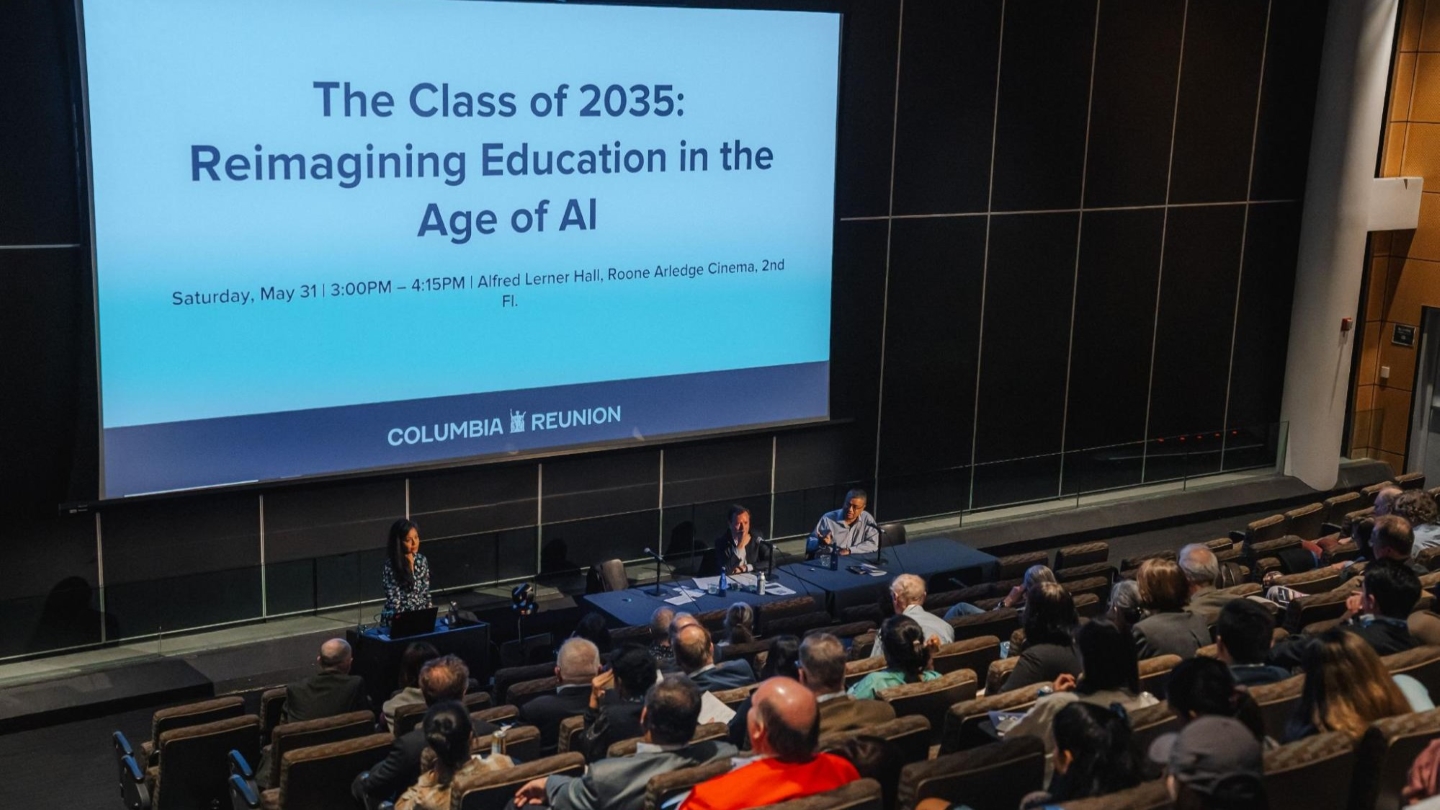 A big screen reads "The Class of 2035: Reimagining Education in the Age of AI" in front of a crowded auditorium