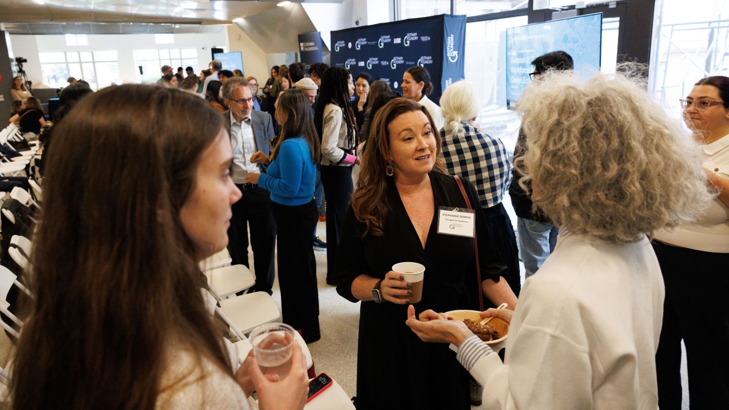 Attendees talking in small groups during a networking session at the Gotham Foundry symposium.