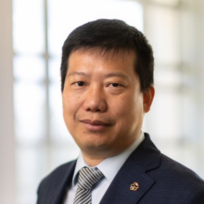 Yan Yao looking at the camera in front of a sunlit window