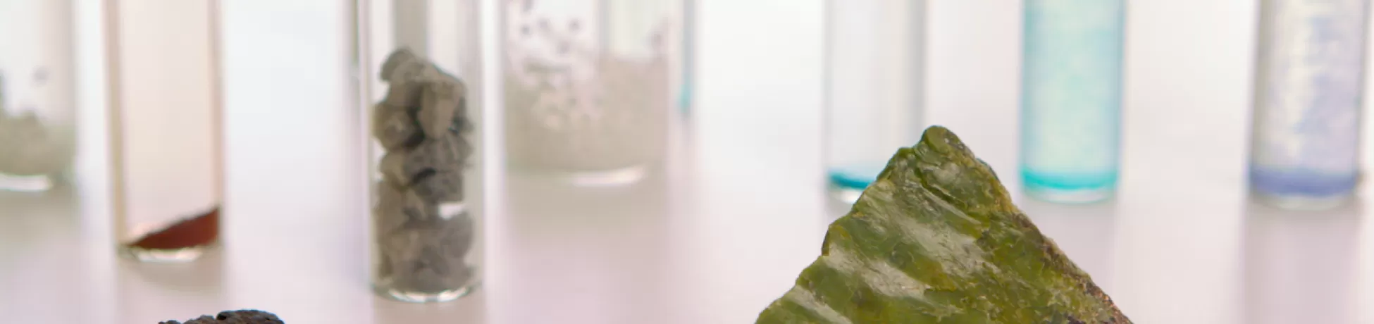 Two mineral samples set in of small, capped tubes containing different substances