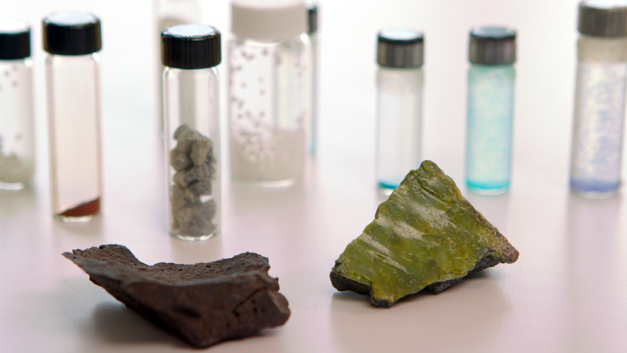 Two mineral samples set in of small, capped tubes containing different substances