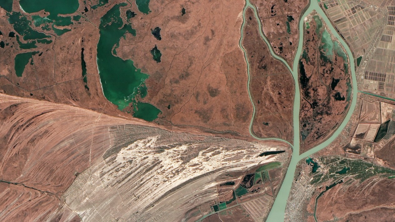 A satellite view of a river carving through the surrounding landsacpe