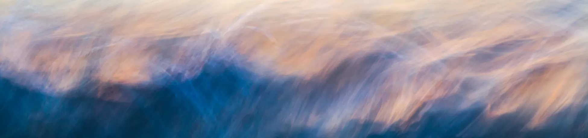 A blurry photo of an ocean wave