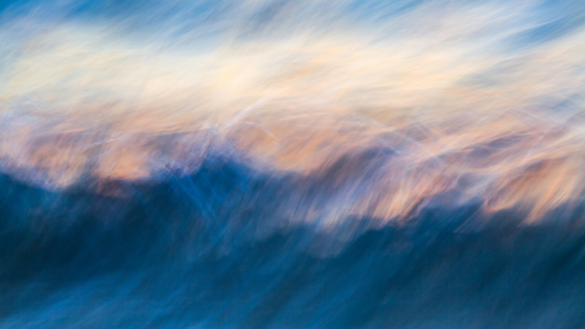 A blurry photo of an ocean wave